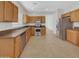 Kitchen features light wood cabinets, stainless steel appliances, and tile flooring at 11168 E Lost Canyon Ct, Gold Canyon, AZ 85118