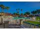 Inviting community pool with lounge chairs and palm trees at 14300 W Bell Rd # 505, Surprise, AZ 85374