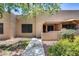Tan stucco condo building exterior with walkway and patio at 14300 W Bell Rd # 505, Surprise, AZ 85374