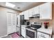 Modern kitchen with stainless steel appliances and white cabinets at 14300 W Bell Rd # 505, Surprise, AZ 85374