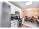 Kitchen with stainless steel appliances, white cabinets, and adjacent dining area at 14300 W Bell Rd # 505, Surprise, AZ 85374