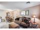 Living area with sofa, dining table, and decorative mirror at 14300 W Bell Rd # 505, Surprise, AZ 85374