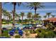 Relaxing pool area with palm trees and seating at 16222 W Talara Way, Surprise, AZ 85374