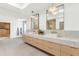 Spa-like bathroom with double vanity, marble counters and large mirrors at 4350 N Jokake Dr, Scottsdale, AZ 85251