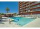 Community pool with lounge chairs and a covered patio area at 4750 N Central Ave # 8B, Phoenix, AZ 85012