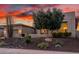 Stunning desert contemporary home with landscaped yard at sunset at 11796 W Creosote Dr, Peoria, AZ 85383