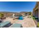 Resort-style backyard oasis with a large pool, spa, and outdoor kitchen at 11796 W Creosote Dr, Peoria, AZ 85383