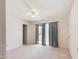 Comfortable bedroom with ceiling fan, carpet, and access to patio at 16336 E Palisades Blvd # 9, Fountain Hills, AZ 85268