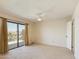 Bright bedroom with carpet, ceiling fan, and sliding glass door to balcony at 16336 E Palisades Blvd # 9, Fountain Hills, AZ 85268
