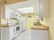 Efficient kitchen with white cabinets, wood countertops, and modern appliances at 16336 E Palisades Blvd # 9, Fountain Hills, AZ 85268