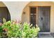 Attractive entryway with wrought iron security door and colorful flowers at 16336 E Palisades Blvd # 9, Fountain Hills, AZ 85268