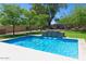 Relaxing pool area with a stone water feature at 10220 E Cochise Dr, Scottsdale, AZ 85258