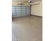 Clean and spacious garage interior with epoxy flooring at 10220 E Cochise Dr, Scottsdale, AZ 85258