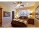 Cozy bedroom with a leopard print comforter and ceiling fan at 10220 E Cochise Dr, Scottsdale, AZ 85258