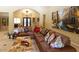 Spacious living room with a large leather sectional sofa and large artwork at 10220 E Cochise Dr, Scottsdale, AZ 85258