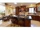 Gourmet kitchen with granite countertops, large island, and wooden cabinetry at 10220 E Cochise Dr, Scottsdale, AZ 85258