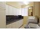 Laundry room with granite countertops and plenty of cabinet space at 10220 E Cochise Dr, Scottsdale, AZ 85258