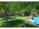 Landscaped backyard with large trees and lawn at 10220 E Cochise Dr, Scottsdale, AZ 85258