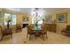 Formal dining room with a round table and fireplace at 10220 E Cochise Dr, Scottsdale, AZ 85258