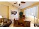 Home office features a large desk, comfortable chair, and natural light at 10220 E Cochise Dr, Scottsdale, AZ 85258