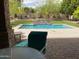 Relaxing pool view from covered patio seating at 10220 E Cochise Dr, Scottsdale, AZ 85258