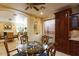 Bright dining room with glass-top table and wood chairs, adjacent to kitchen at 10220 E Cochise Dr, Scottsdale, AZ 85258
