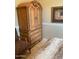 Bedroom with an ornate armoire and seating at 10220 E Cochise Dr, Scottsdale, AZ 85258