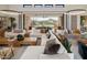 Open living area features a spacious sectional sofa, large windows, and backyard access at 24046 N 126Th Pl, Scottsdale, AZ 85255