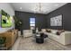 Stylish game room with comfortable seating, large TV, and plenty of natural light at 24046 N 126Th Pl, Scottsdale, AZ 85255