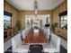 Open concept dining room with a long wooden table and views into the kitchen at 24046 N 126Th Pl, Scottsdale, AZ 85255