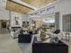 Spacious living area with a fireplace, large windows, and comfortable seating at 24046 N 126Th Pl, Scottsdale, AZ 85255