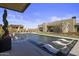 Stunning pool with built in seating and lounge chairs at 24046 N 126Th Pl, Scottsdale, AZ 85255