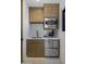 Compact kitchenette with modern cabinetry, microwave, and undercounter refrigerator at 24046 N 126Th Pl, Scottsdale, AZ 85255