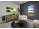 Cozy sitting area with a TV, window, and stylish furniture at 24046 N 126Th Pl, Scottsdale, AZ 85255
