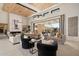 Spacious living area with high ceilings, a fireplace, and access to a patio at 24046 N 126Th Pl, Scottsdale, AZ 85255
