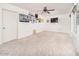 Bright living room featuring carpet flooring and a ceiling fan at 9710 W Campana Dr, Sun City, AZ 85351