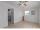 Bedroom featuring tile flooring, ceiling fan, and ensuite bathroom access at 2226 N 61St Ave, Phoenix, AZ 85035