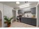 Kitchen with gray shaker cabinets, stainless steel appliances, and a white brick accent wall at 2226 N 61St Ave, Phoenix, AZ 85035