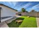 Artificial turf backyard with cornhole and grill area at 1408 W 7Th St, Tempe, AZ 85281