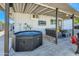 Covered patio with hot tub, seating area, and artificial turf at 1408 W 7Th St, Tempe, AZ 85281