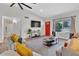 Open living room showcasing a red door, hardwood floors, and ample natural light at 3406 E Libby St, Phoenix, AZ 85032
