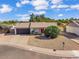 Attractive single-story home with a red door, well-manicured landscaping, and a two-car garage at 3406 E Libby St, Phoenix, AZ 85032