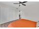 Bedroom with orange bedding and ceiling fan at 3406 E Libby St, Phoenix, AZ 85032