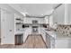 Modern kitchen with white cabinets, stainless steel appliances, and quartz countertops at 3406 E Libby St, Phoenix, AZ 85032