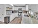 Well-equipped kitchen featuring white cabinets, stainless steel appliances, and stylish backsplash at 3406 E Libby St, Phoenix, AZ 85032