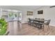 Modern dining area with a sleek table, bench seating, and access to the kitchen at 3406 E Libby St, Phoenix, AZ 85032