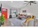 Spacious living room with hardwood floors, a red front door, and a cozy seating area at 3406 E Libby St, Phoenix, AZ 85032