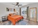 Bedroom with orange bedding and ceiling fan at 3406 E Libby St, Phoenix, AZ 85032