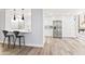 Modern white kitchen with stainless steel appliances and breakfast bar at 8634 E Monterosa Ave, Scottsdale, AZ 85251