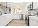 Bright white kitchen featuring stainless steel appliances and ample cabinetry at 8634 E Monterosa Ave, Scottsdale, AZ 85251